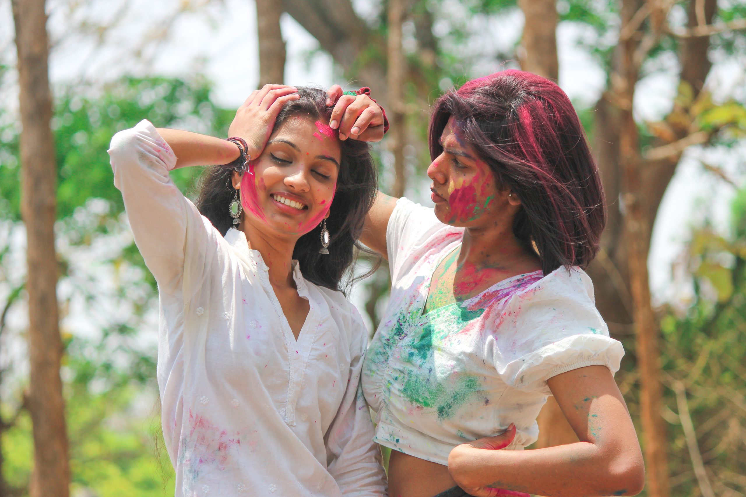 Stylish girls posing with Holi colors