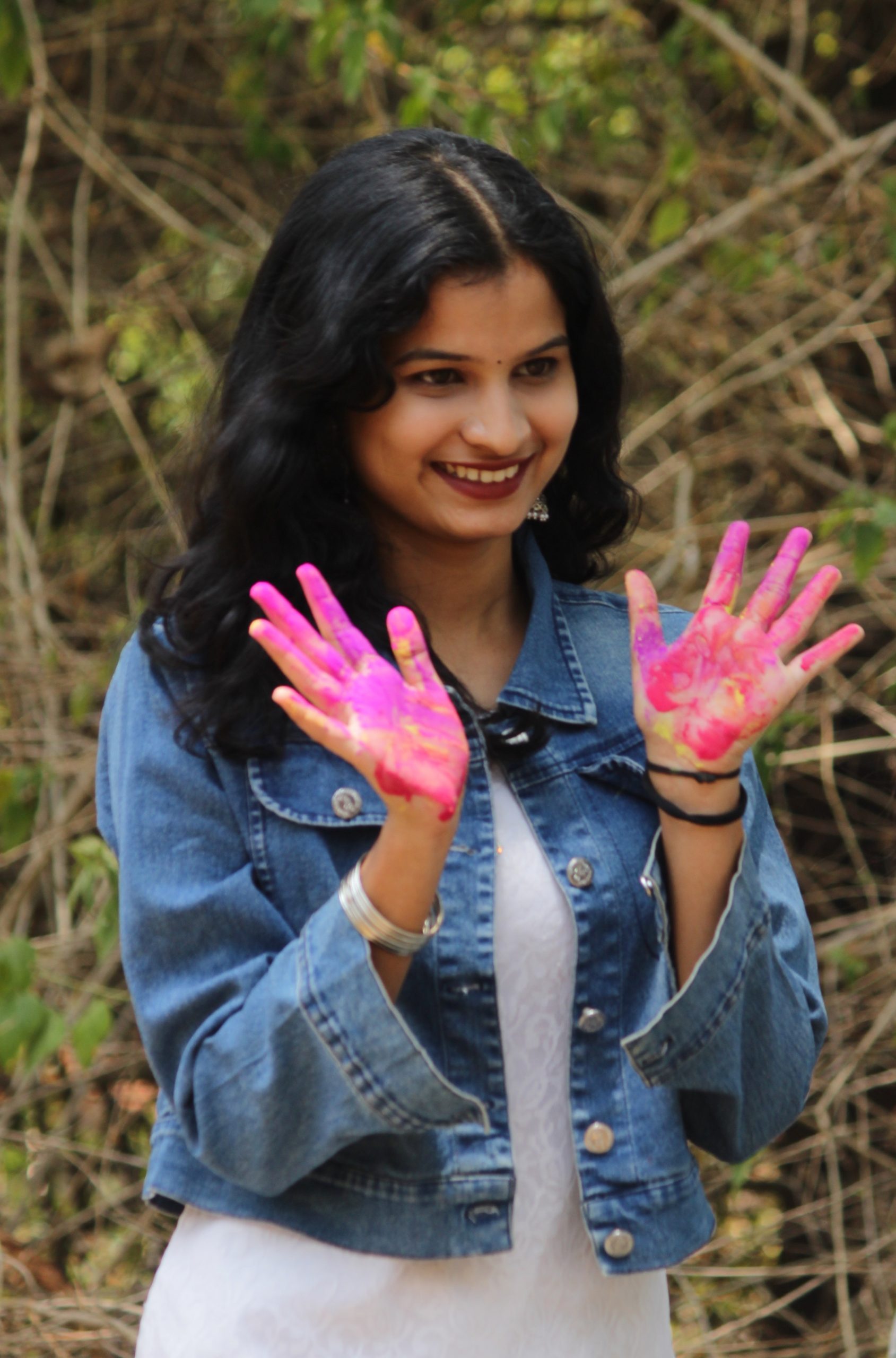 A girl showing her hands painted with Holi colors