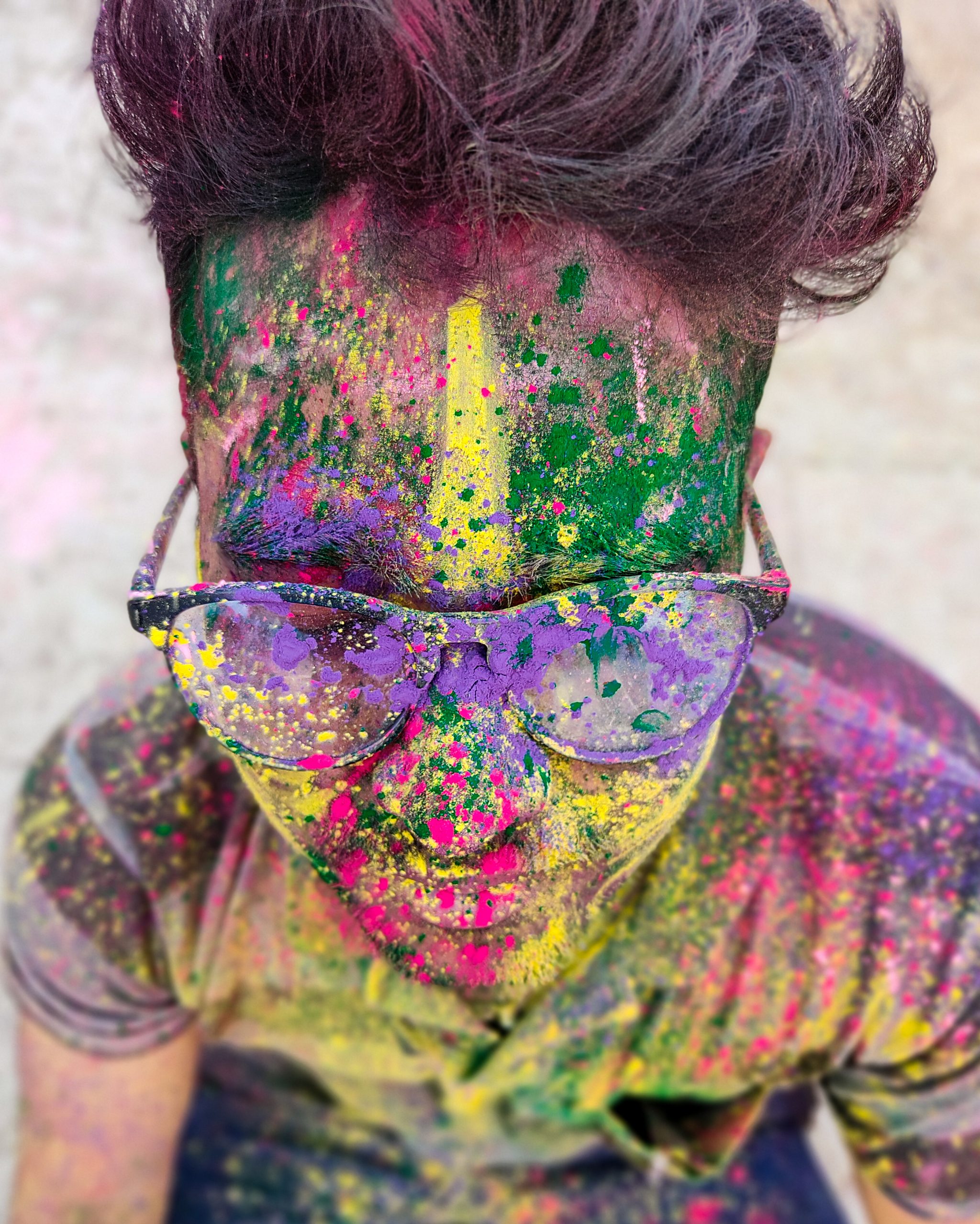 A boy's face painted with Holi colors