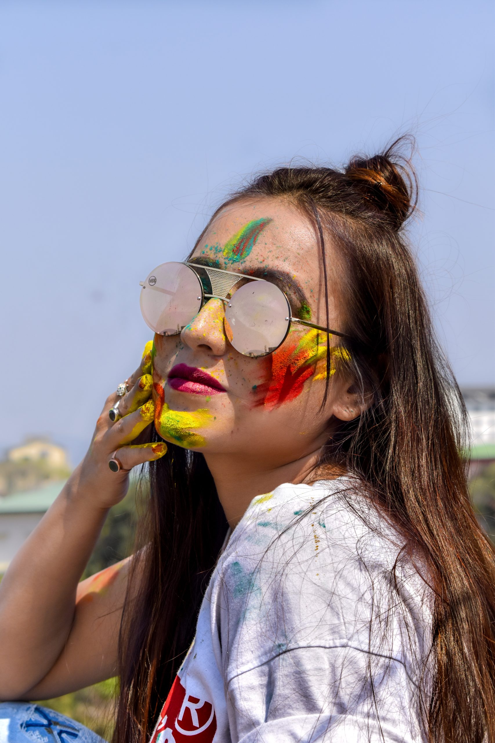 Long hair girl with sunglasses playing with colors