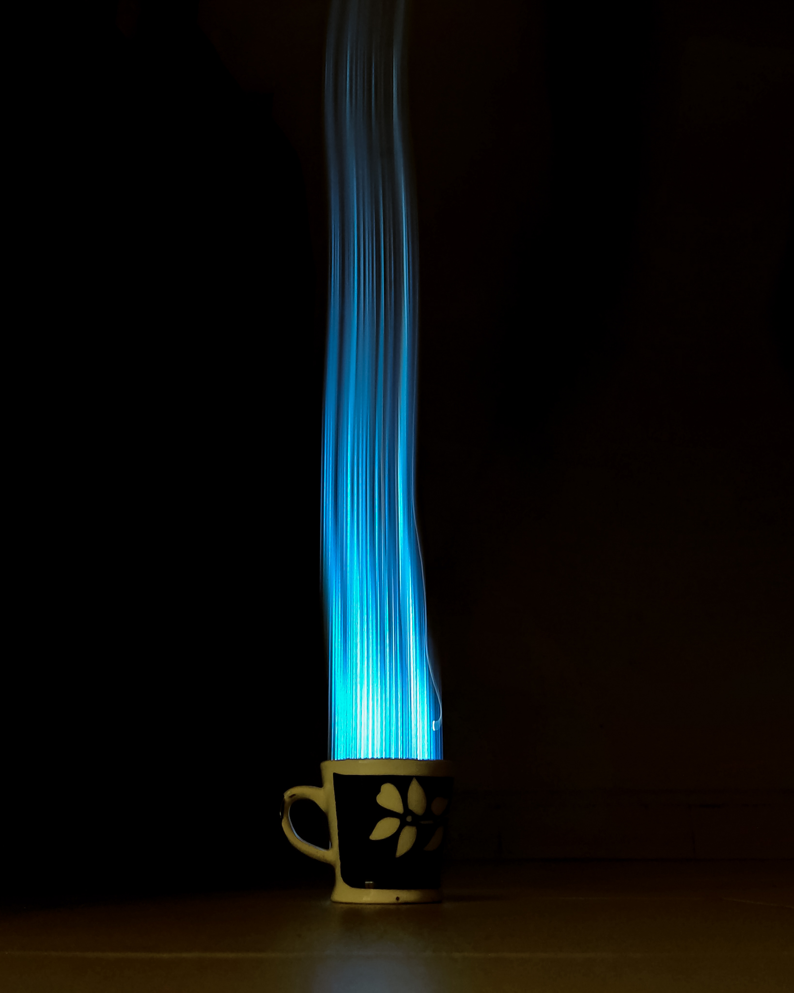 Blue lights beaming from a cup