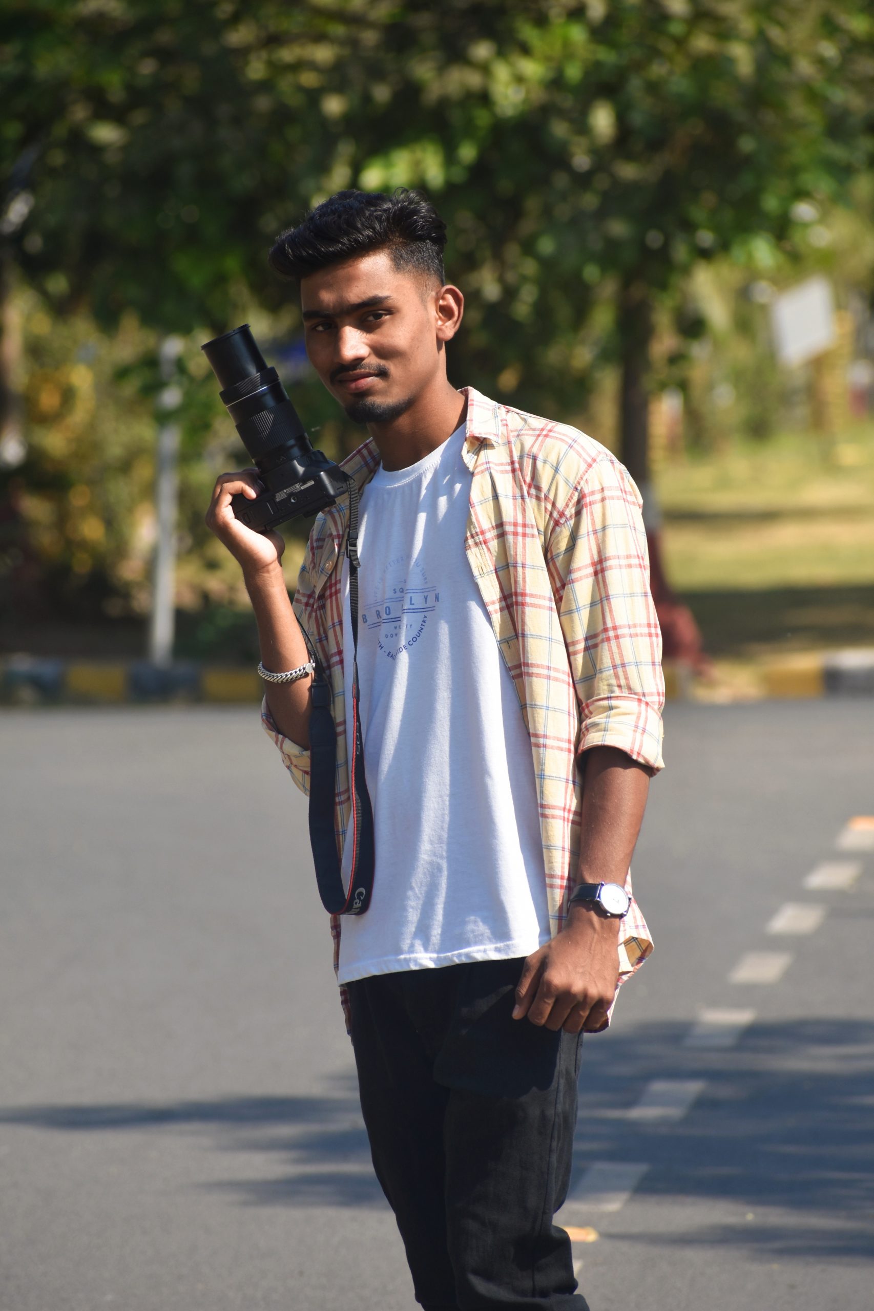 Stylish boy posing with camera