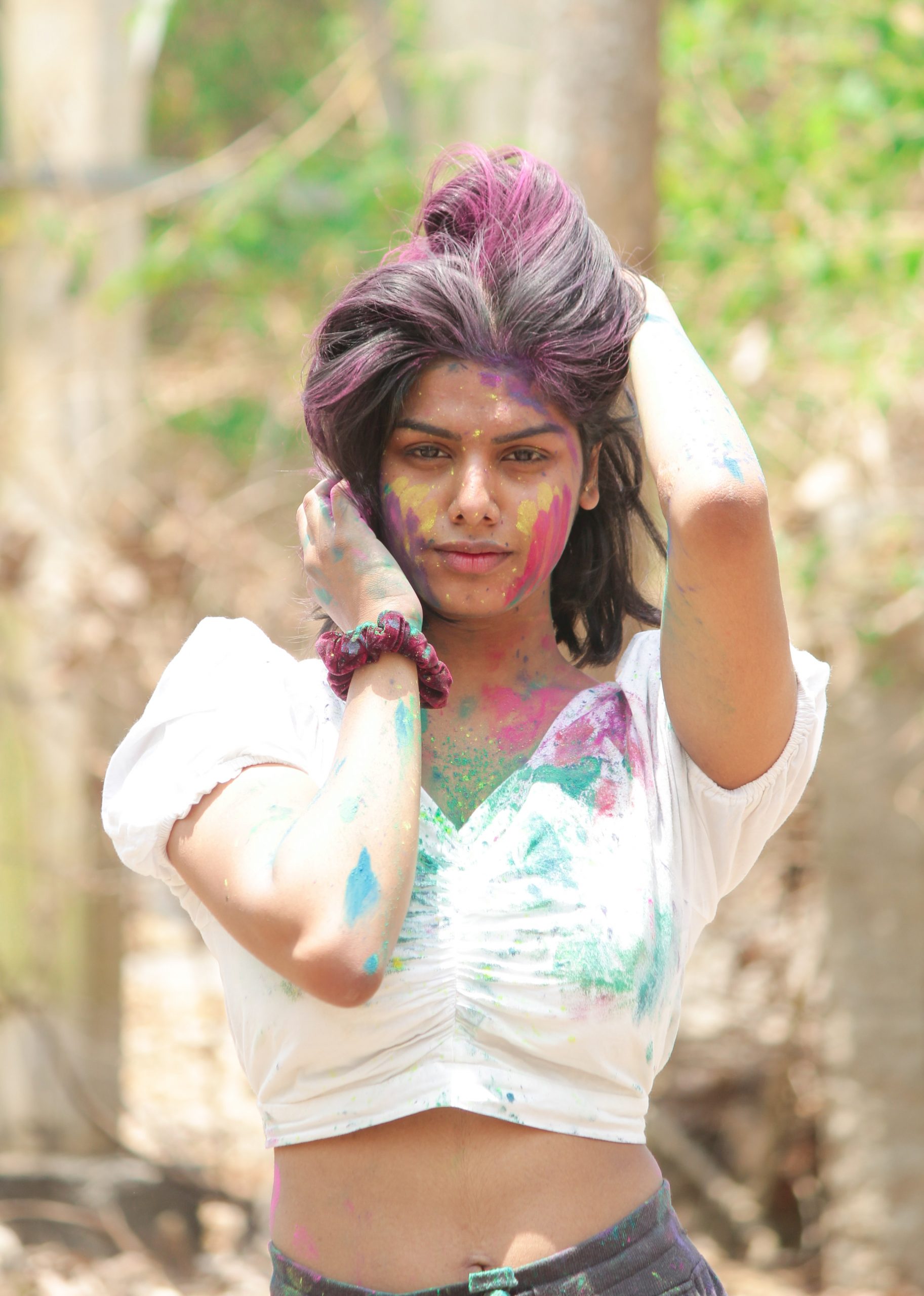 Stylish girl posing with Holi colors