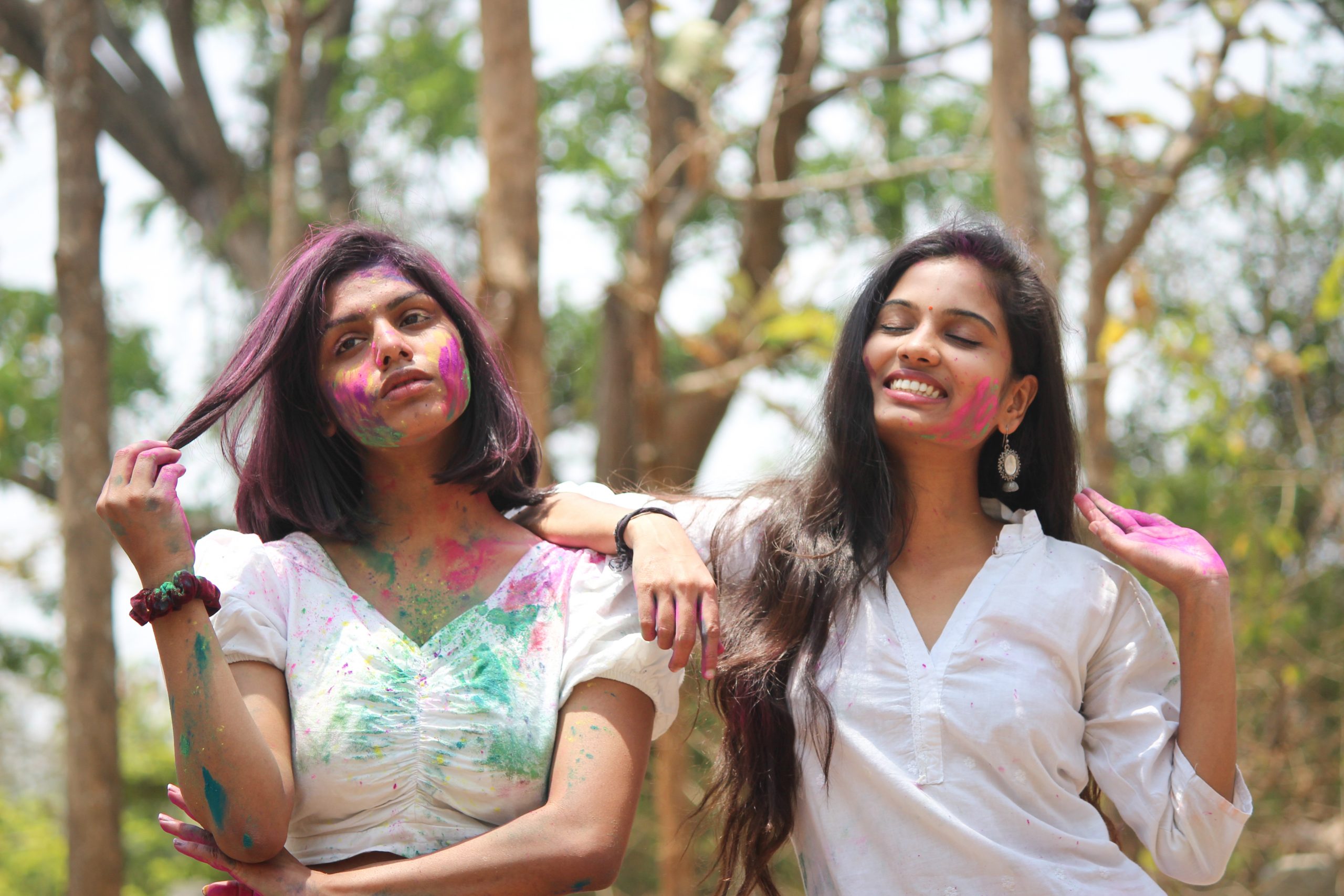 Stylish girls posing with Holi colors