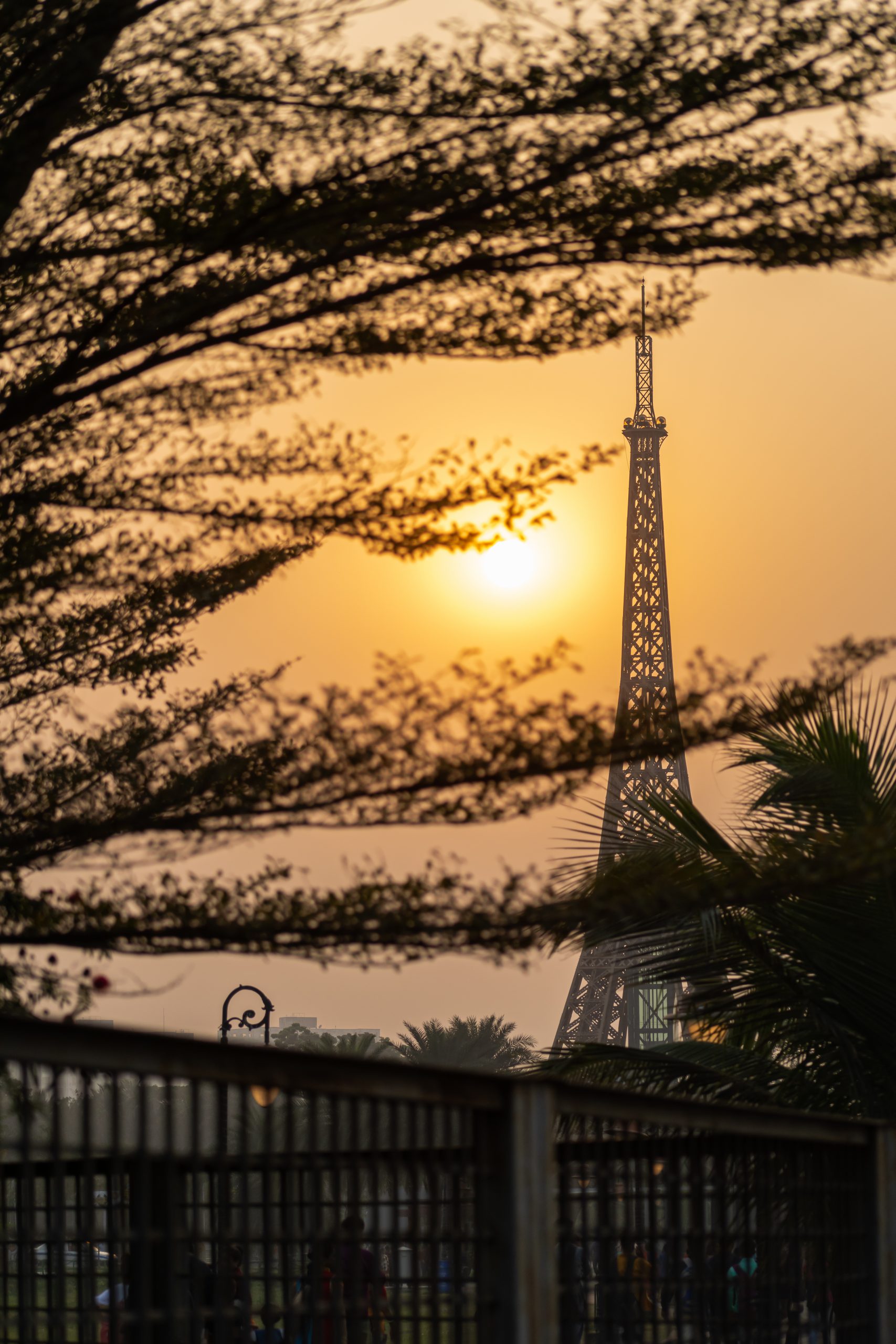Sunset behind the model of Eiffel Tower