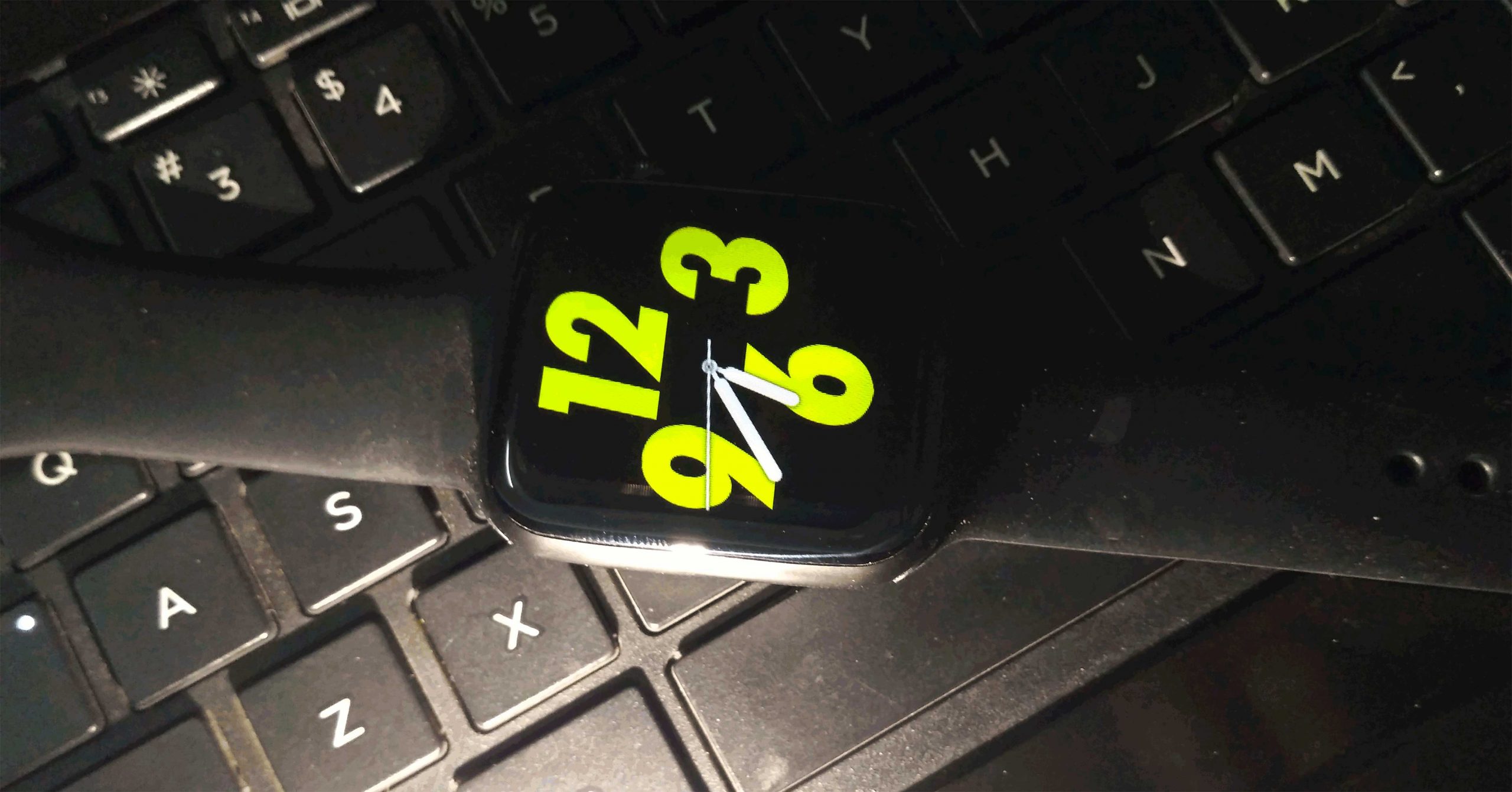 black smart watch placed on a keyboard