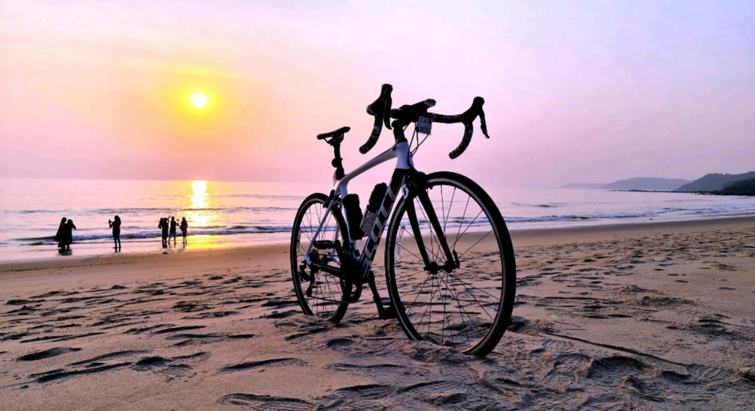 A bicycle and sunset at a beach