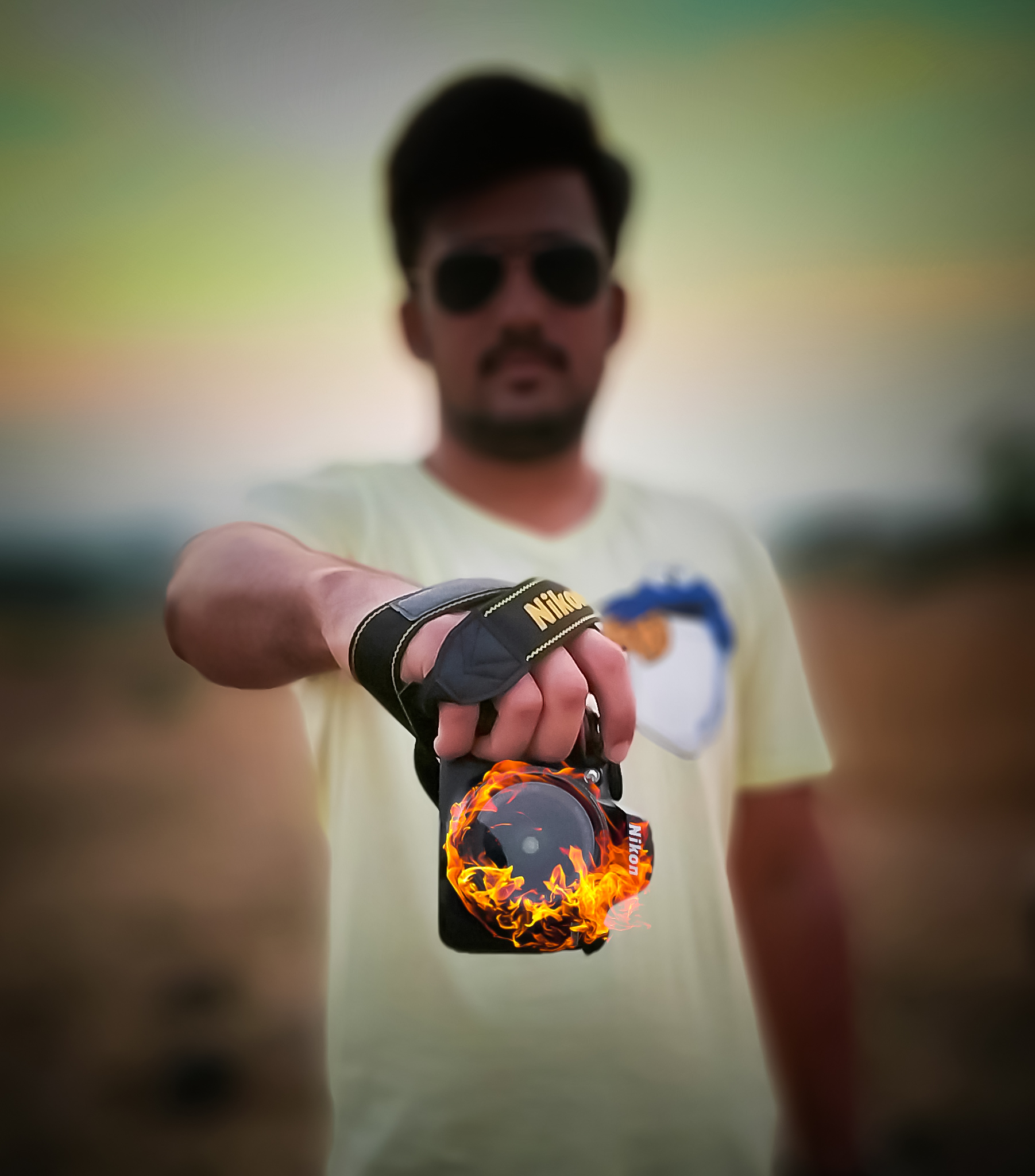 A man showing a burning camera