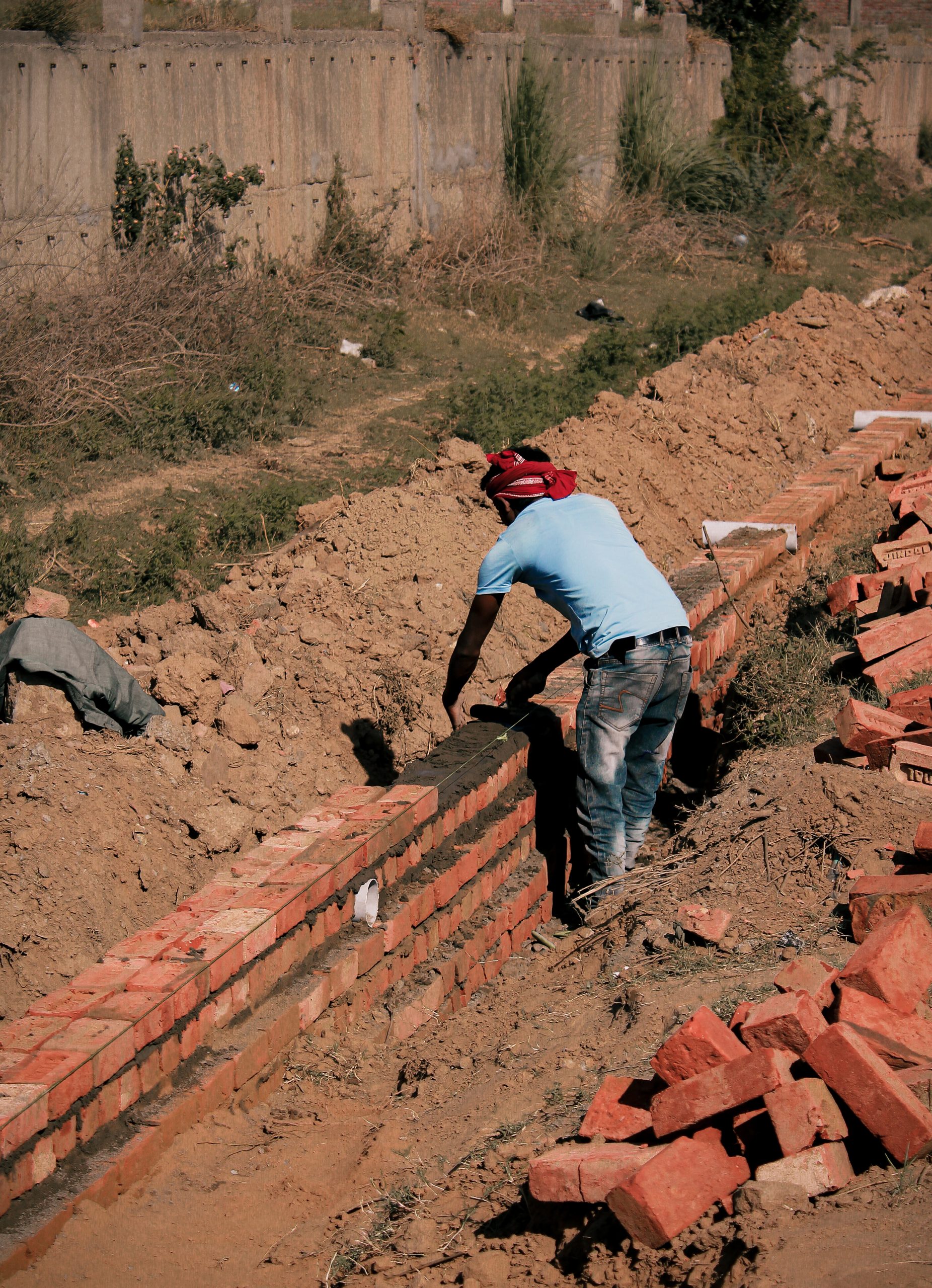 A worker making a brick wall