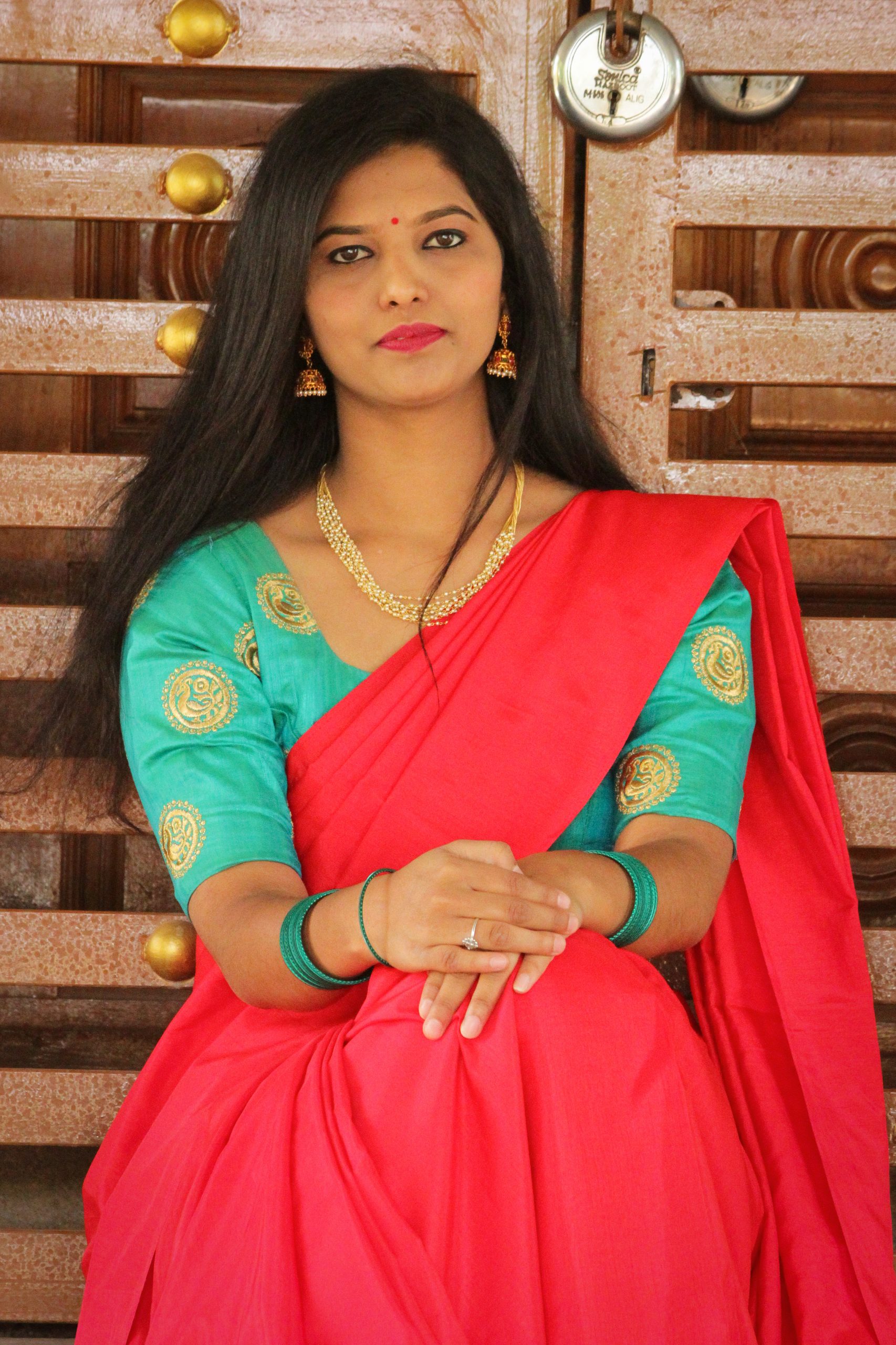 An Indian woman in red dress