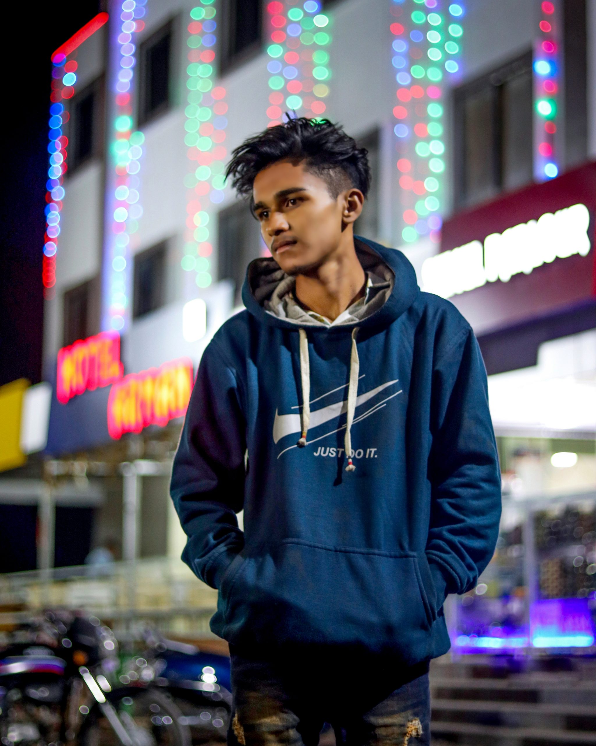 Boy posing outside building at night