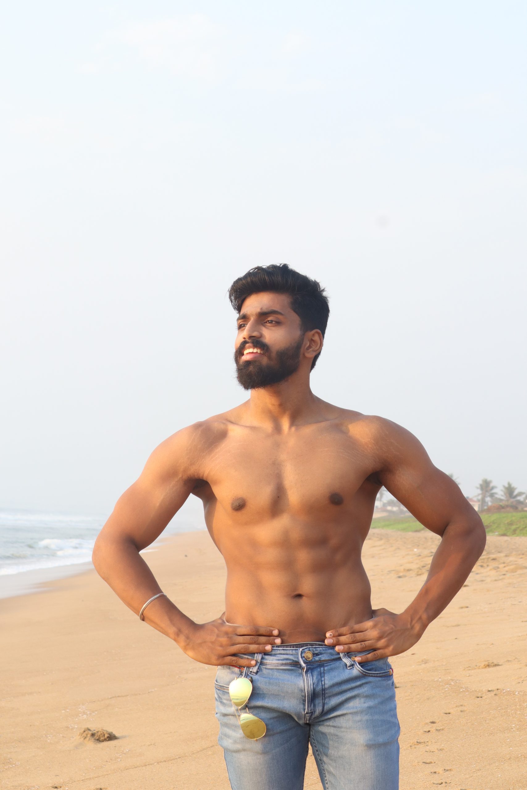 Fitness model posing on beach