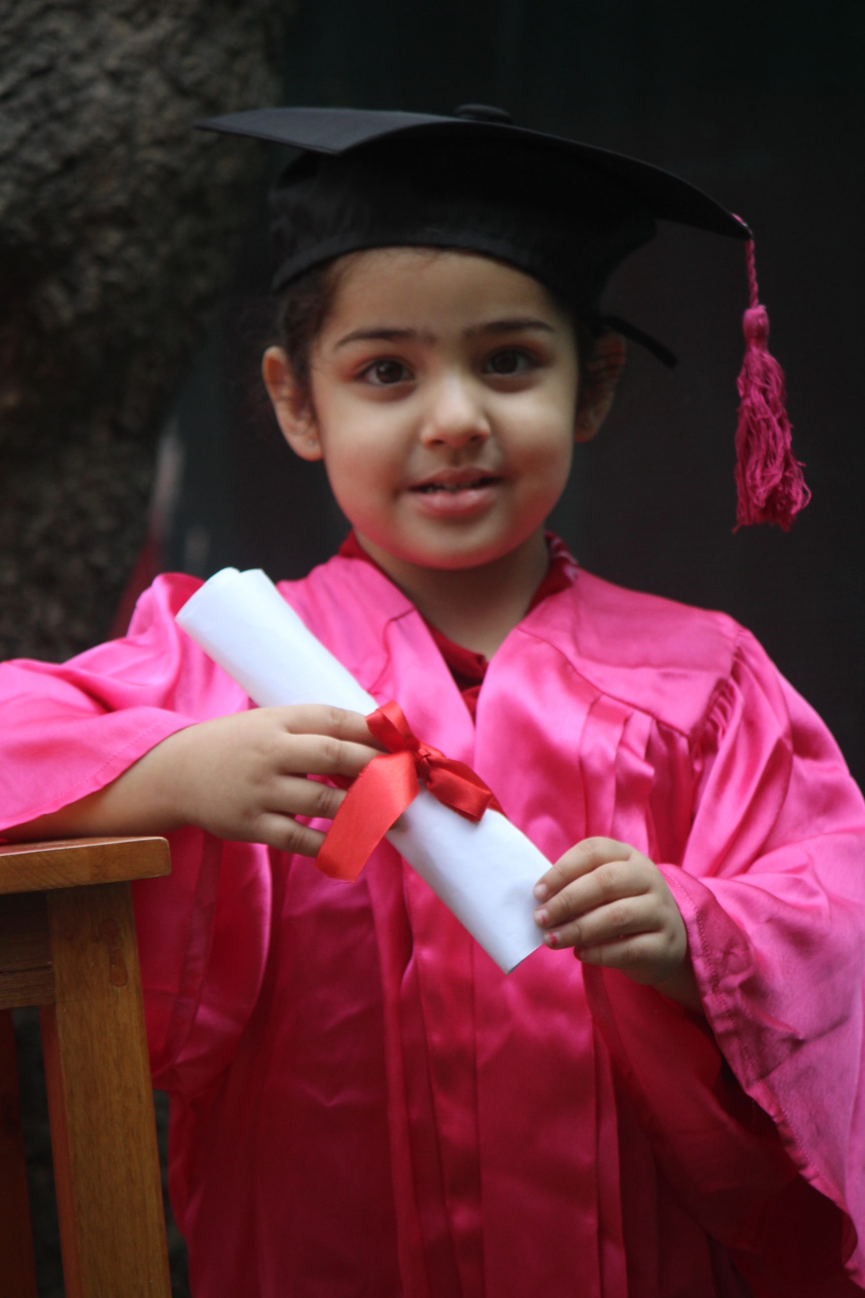 A little girl in graduation day getup