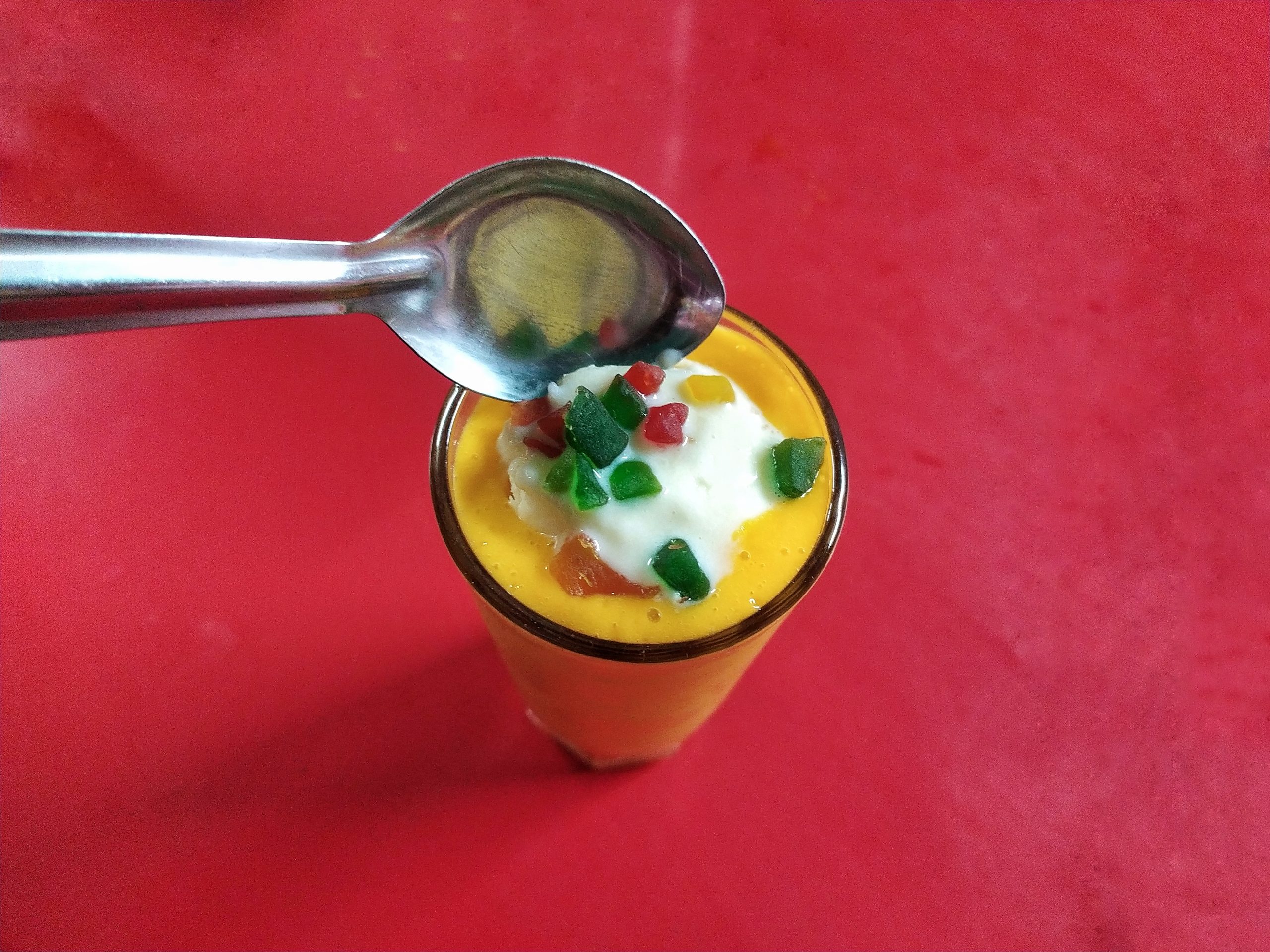 Mango juice glass and a spoon