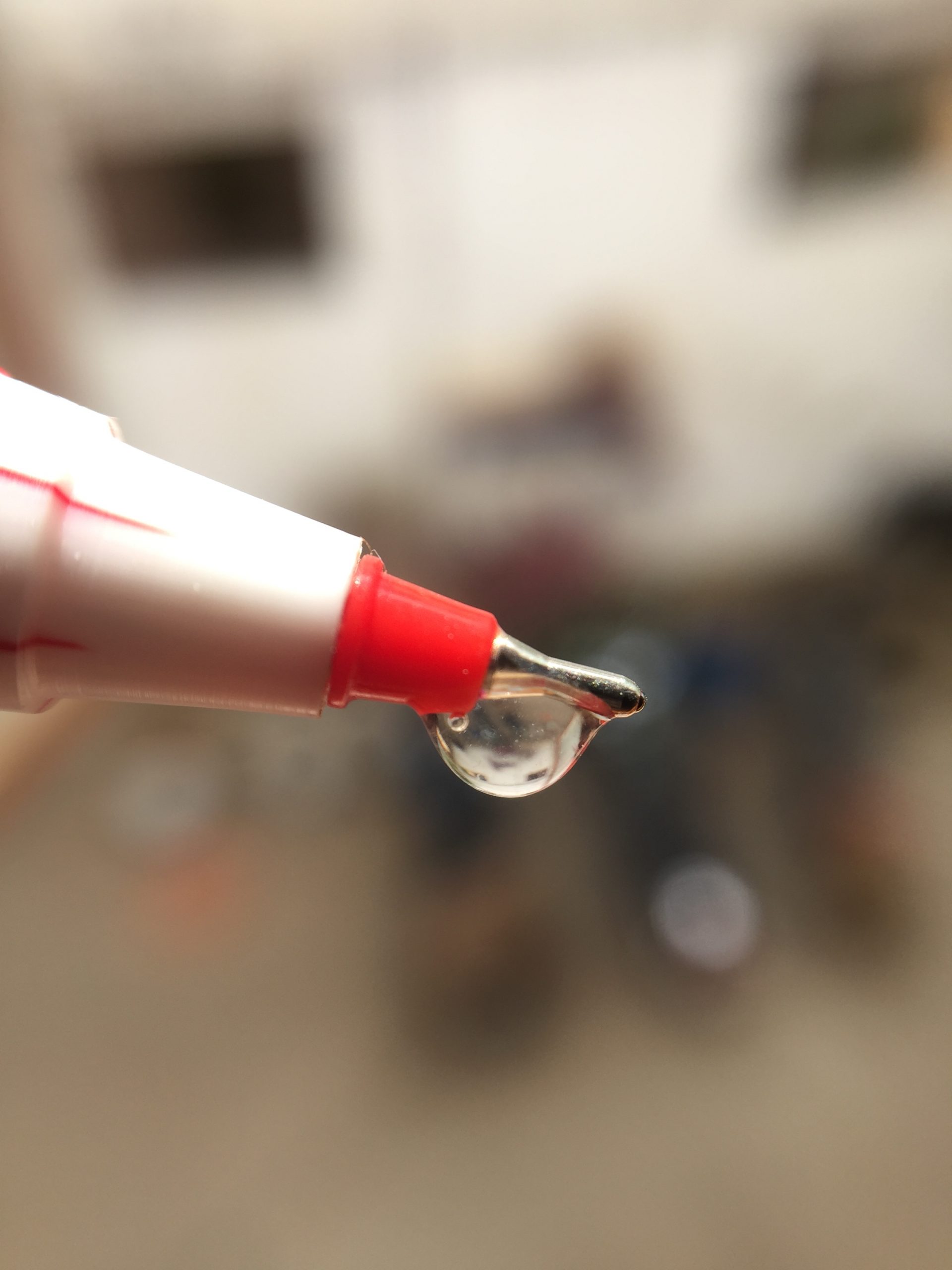 Water drop on the tip of a pen