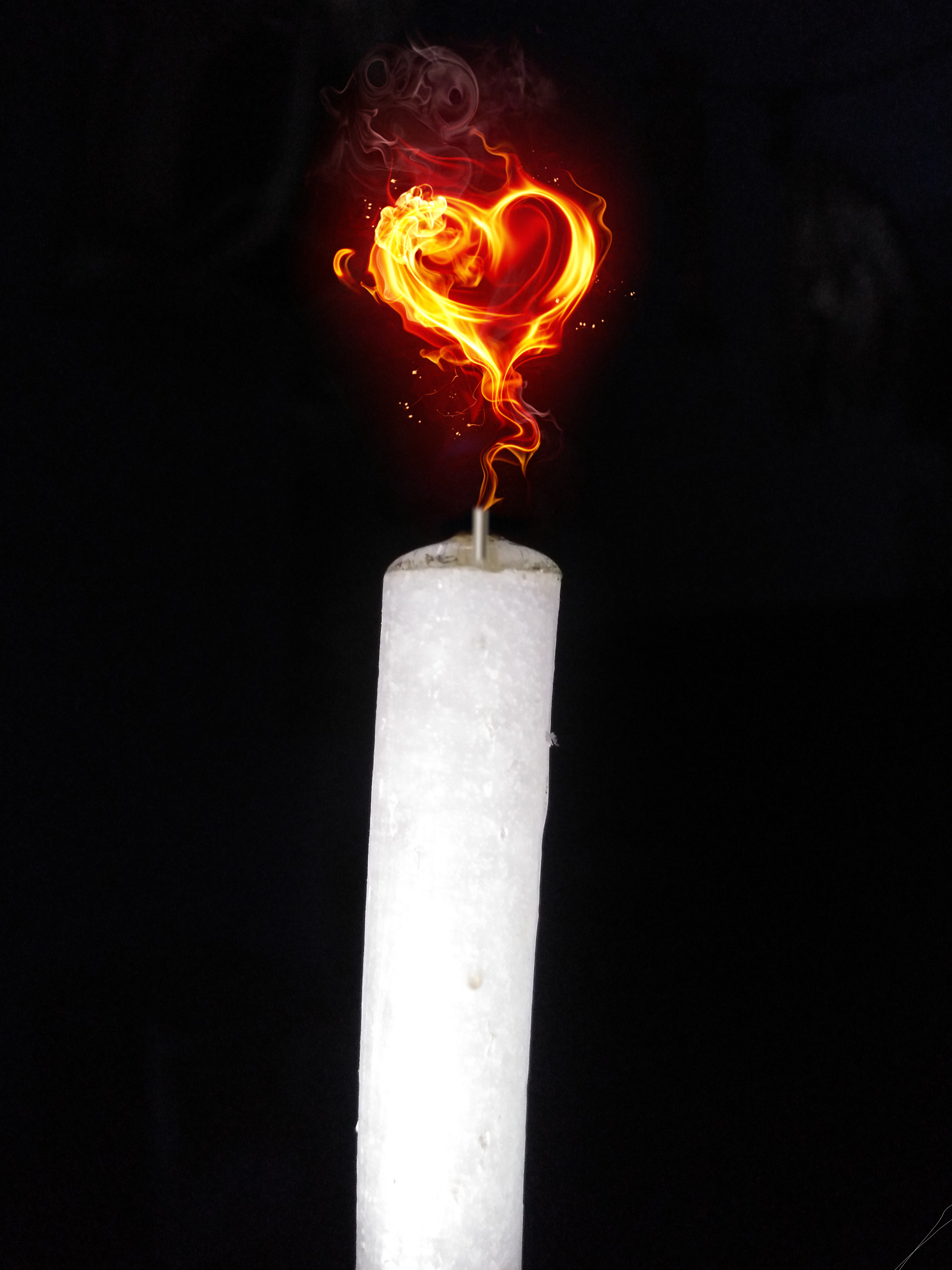 Flame in heart shape on candle